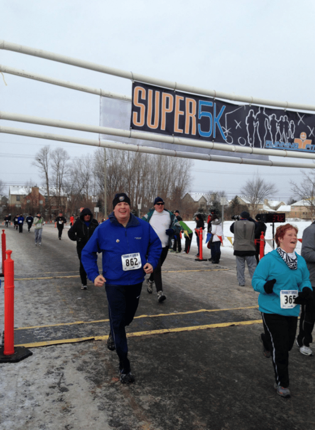 Doug Selby Crossing The Finish Line IN a 5K Race