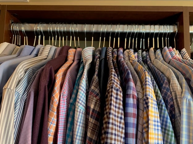 Photo of thin plastic hangers being used in a closet